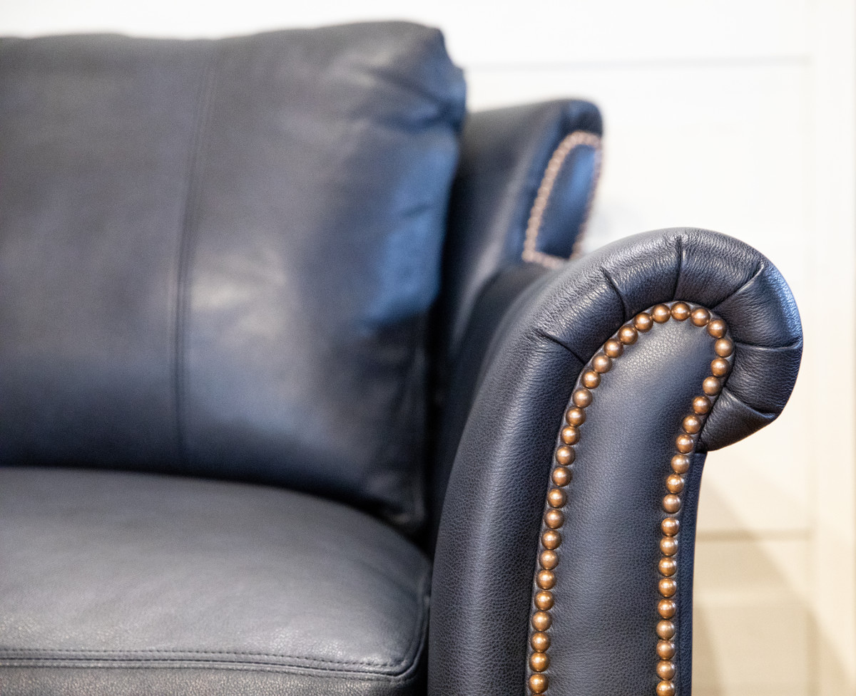 Leather sofa detail with rolled arm and naihead trim upholstery from Farmville, Virginia furniture store showroom