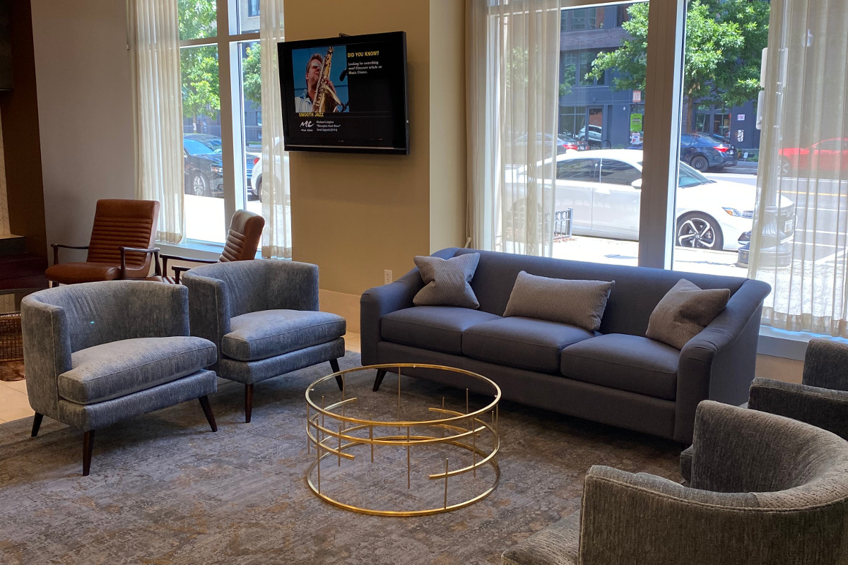Green Front Furniture showroom living room display with sofa, accent chairs, coffee table and area rug in farmville.